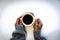 African woman hands holding a white cup of coffee. Black Female hands holding a hot cup of coffee with foam over backgrou