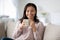 African woman holding cup enjoy coffee pause at home