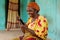african woman holding her smartphone rejoices