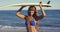 African Woman Holding Surfing Board Overhead