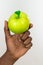 African woman holding up delicious green apple isolated on a white background