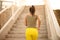 African woman jogging on the stairs. View from back