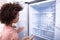 African Woman Looking At Empty Refrigerator