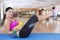 African woman practicing yoga with a dumbbell