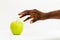 African woman reaching for delicious green apple in open palm isolated on a white background