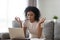 African woman reducing stress do yoga exercise to calm down