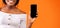African Woman Showing Phone Screen Over Orange Background, Cropped, Mockup