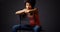 African woman sitting casually with arms over back of chair