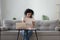 African woman sitting at coffee table holding pen writing