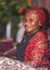 African woman sitting and waiting happily at the hotel entrance