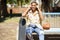 African woman with skateboard relaxing after riding skateboard listening to the music