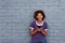 African woman smiling and holding cell phone