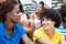 African woman speaking with girlfriend outdoor with multiethnic group