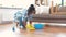 African woman with sponge cleaning floor at home