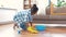 African woman with sponge cleaning floor at home