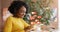 African Woman Using Social Media On Tablet Sitting In Cafe