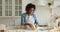 African woman wear apron kneading dough preparing cookies in kitchen