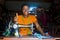 african woman who is a tailor working on a dress smiling, gives a thumbs up