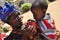 African women feeding child