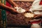 African women`s hands holding a cup of coffee and straw bowl with popcorn, a traditional way of preparing coffee in