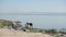 African women standing on the shore of the lake and washing dishes in sunny day.