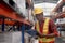 African worker wearing safety vest and helmet, holding file folder document at warehouse factory. Male logistics staff checking