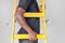 African worker with wooden ladder