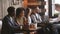 African young man and woman talking sitting at coffeeshop table