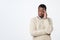 african young thinking man looks up with hand near face isolated on white background