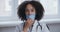 African young woman doctor professional sitting at workplace in hospital clinic feeling sadness fatigue stress and