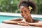 African young woman relaxing on swimming pool edge