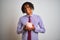 Afro american businessman with dreadlocks holding piggybank over  white background with a happy face standing and smiling