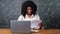 Afro-american businesswoman opens envelope and enters code