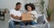 Afro american couple black husband and wife consumers buyers receive parcel by mail from internet store with interest