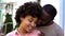 Afro-american couple enjoying date, girl feeling safe in boyfriend arms, smiling