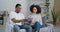 Afro american couple young family sitting on couch quarreling over documents received letter from bank husband learns