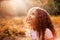 Afro american cute little girl with curly hair receives miracle sun rays from the sky