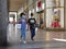 Afro american ethnicity female teens strolling downtown for shopping wearing protective mask