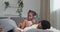 Afro american family black ethnic african parents lying on couch resting man father hiding under pillow little daughter