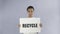 Afro-American girl activist with recycle poster showing thumb up on grey background