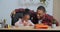 Afro american guy loving father helping little cute preschool daughter to draw picture do homework supports child gives