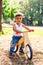 Afro-american or latin little boy ride bicycle and smiling