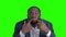 Afro american man making grimace on green screen.