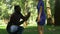 Afro-american man making proposal to girlfriend while they walking in park