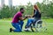 Afro american man marriage proposal giving a ring to his redhaired ginger girlfriend.she sitting on wheel chair and