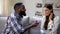 Afro-American man presenting surprised lady engagement ring, proposing marriage