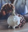 Afro-american Man Putting Money in Piggy Bank.