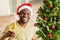 afro american man raised a glass of champagne and makes a toast at home