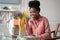 Afro-American millennial woman with afro hairstyle remote studying, working online on laptop, chatting with friends via video call