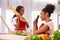 Afro American mother and daughter in aprons